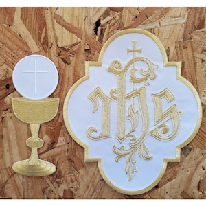 May include: White embroidered patch with gold thread depicting the monogram "IHS" with a cross above the "H". The patch is surrounded by a gold border and has a scalloped edge. A white communion wafer with a gold cross is on top of a gold chalice.