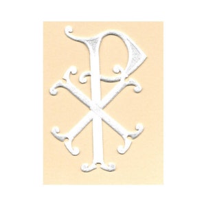 May include: White embroidered Chi Rho symbol on a light beige background.