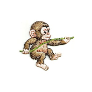 May include: Embroidered patch of a brown monkey holding a green vine. The monkey has a pink nose and ears.