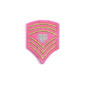May include: Pink felt chevron patch with gold and silver glitter accents and a white heart in the center.