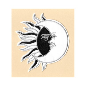 May include: Black and white embroidered patch of a sun and moon with a face. The sun has a silver outline and the moon has a white outline.