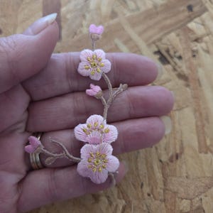 May include: A set of three ceramic mugs with a speckled, matte finish. The mugs are in shades of cream, light gray, and dark gray. Each mug has a simple, minimalist design, perfect for coffee or tea.