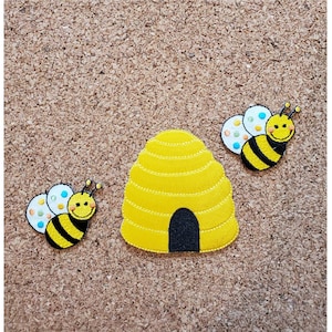 May include: Two yellow and black bees with white spots and smiling faces, and a yellow and black beehive with a black entrance.
