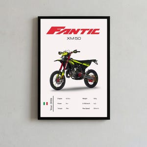 May include: A framed poster featuring a Fantic XM 50 motorcycle in black and neon yellow. The text FANTIC XM 50 appears at the top. Below the motorcycle, technical specifications are listed, including engine, power, torque, weight, and speed.