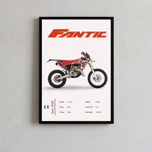 May include: A framed poster featuring a red and white Fantic dirt bike centered on a white background. The text FANTIC appears in red at the top. Below the bike, technical specifications are listed including Year: 2023, Engine: 324.3cc, Power: 38cv, Torque: 25Nm, Weight: 103kg, 0-100 km/h: 5.3s, and Max Speed: 120km/h, alongside an Italian flag icon.