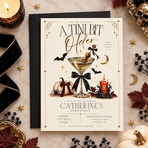 May include: A cream-coloured birthday invitation card featuring a martini glass with a black bow, a pumpkin, a spider, bats, a crescent moon, and a candle. The text reads: A TINI BIT Older, SAME WICKED SPIRIT, JOIN US TO CELEBRATE CATHERINE'S BIRTHDAY.