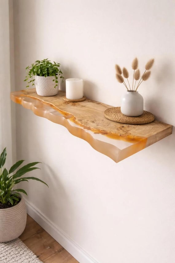 A live-edge wood floating shelf with a glowing amber epoxy 'river' running through it — functional meets small-batch art.