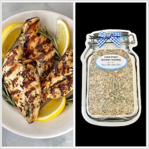 May include: A white plate holding grilled chicken breasts seasoned with herbs and garnished with fresh rosemary sprigs and lemon wedges, alongside a jar-shaped package of Lemon Pepper Rosemary Seasoning by Aimee's Blue Ribbon Spice.