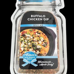 May include: A clear, jar-shaped pouch containing Buffalo Chicken Dip spice mix. The label features the text BUFFALO CHICKEN DIP, SPICE MIX, Aimee's BLUE RIBBON SPICES, and Homemade... Made Easy!, along with an image of prepared dip in a black bowl.