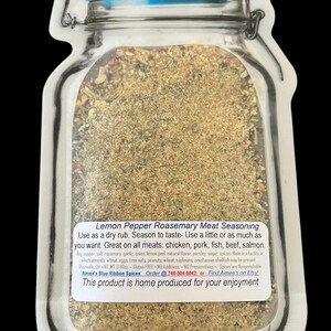 May include: A jar-shaped pouch containing Lemon Pepper Rosemary Meat Seasoning. The label reads: Lemon Pepper Rosemary Meat Seasoning, Use as a dry rub, Season to taste, Great on all meats, 0.80oz, Aim&eacute;e's Blue Ribbon Spices, and more text.