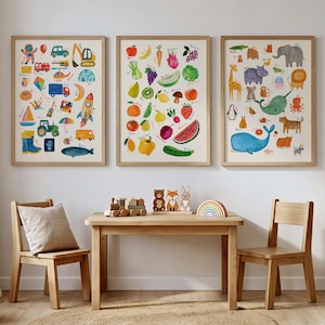 May include: Three framed wall art prints featuring watercolor illustrations. The left print displays various vehicles and objects, the center print shows fruits and vegetables, and the right print depicts a collection of animals, each labeled with text.