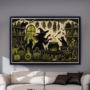 May include: A framed wall art print featuring a black and light green illustration of a witch stirring a bubbling cauldron in a room filled with potion bottles, herbs, two black cats, a pumpkin, and a mortar and pestle under a crescent moon.