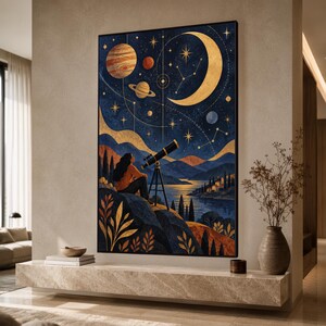 May include: A framed wall art print depicting a person sitting on a rocky cliffside using a telescope to observe a night sky filled with planets, a large golden crescent moon, and stars above a dark blue landscape with a lake and distant hills.