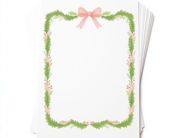 May include: A stack of white stationery sheets with a watercolor design. The border features a green garland with red berries and a pink ribbon. A pink bow is at the top center of the design.