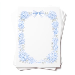 May include: A stack of white stationery featuring a floral design. The design includes light blue hydrangea flowers, a matching ribbon, and a bow. The floral arrangement frames the blank space on the stationery.