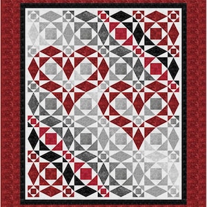 May include: A quilt with a geometric pattern of red, black, and gray squares and triangles. The pattern forms two hearts in the center of the quilt.