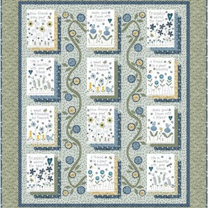 May include: A quilt featuring twelve rectangular blocks with embroidered floral designs and text including phrases like true friends bring great joy, friendship warms the heart, and life is beautiful with good friends, framed by a green and blue border.