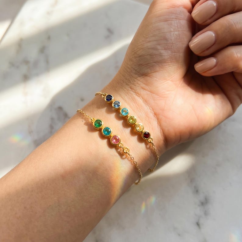 Gold birthstone bar bracelet with colorful round gemstones in a minimalist row, a personalized family bracelet for mothers and grandmothers who love meaningful jewelry.