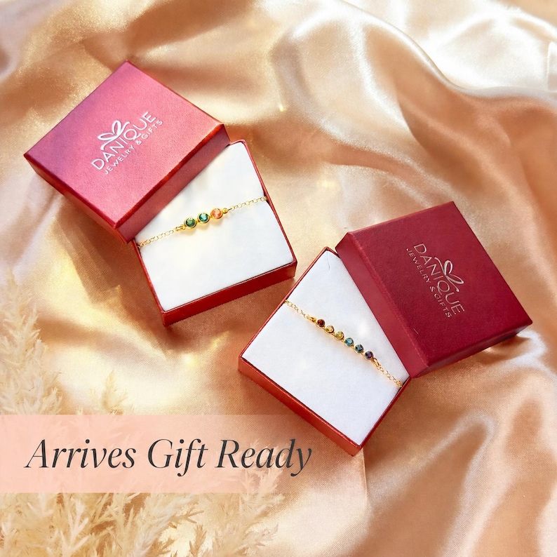 Two red Danique Jewelry gift boxes with Arrives Gift Ready text box in the lower left corner of the image.
