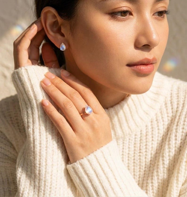 Model wearing matching moonstone ring and moonstone stud earrings in warm sunlight, showing coordinated June birthstone jewelry. A rainbow moonstone ring and earring set idea for birthdays, bridesmaids, Mother’s Day, anniversary gifts, and gemstone jewelry lovers.