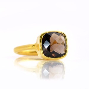 Smoky quartz ring worn on hand, elegant brown gemstone ring in gold setting