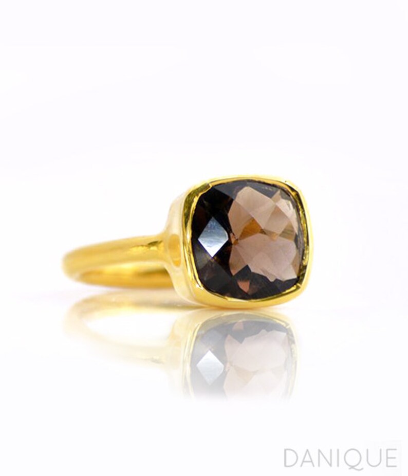 Smoky quartz ring worn on hand, elegant brown gemstone ring in gold setting