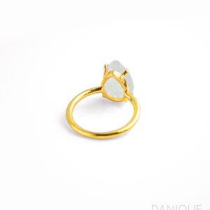 roduct image of moonstone teardrop ring on white background, showing the pear-shaped gemstone, prong setting, and gold band clearly for shoppers. A clean view of the June birthstone ring, gemstone ring, rainbow moonstone ring, and gift for her.