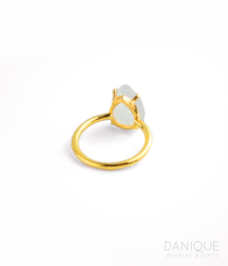 roduct image of moonstone teardrop ring on white background, showing the pear-shaped gemstone, prong setting, and gold band clearly for shoppers. A clean view of the June birthstone ring, gemstone ring, rainbow moonstone ring, and gift for her.