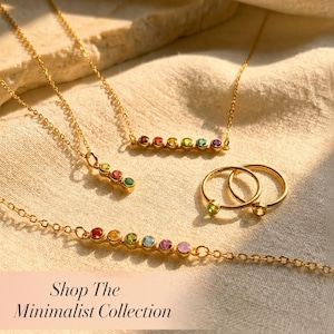 A minimalist birthstone collection featuring necklaces, bracelets and rings. The text on the image says "Shop the Minimalist Collection"