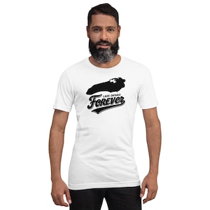 May include: A white short-sleeved t-shirt featuring a black graphic of the Lake Ontario outline positioned above the text "LAKE ONTARIO FOREVER" in a bold, stylized script font. The design is centered on the chest of the garment.