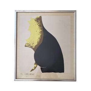 May include: A framed print featuring a stylized graphic illustration with a large, solid black curved shape against a light beige background. A textured, bright yellow form is layered along the left edge. The print is signed and numbered in pencil.