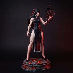 May include: A collectible figurine of a character with long black hair wearing a black sleeveless cheongsam with red flame patterns. The figure holds a dark swirling flame in one hand and stands on a circular base resembling cracked lava with the text AMATERASU.