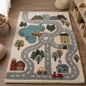 May include: A rectangular area rug featuring a tufted landscape design with a winding gray road, a blue lake with a wooden bridge, green trees, brown mountains, a red barn, a yellow house, a blue building, a yellow car, and a red scooter.