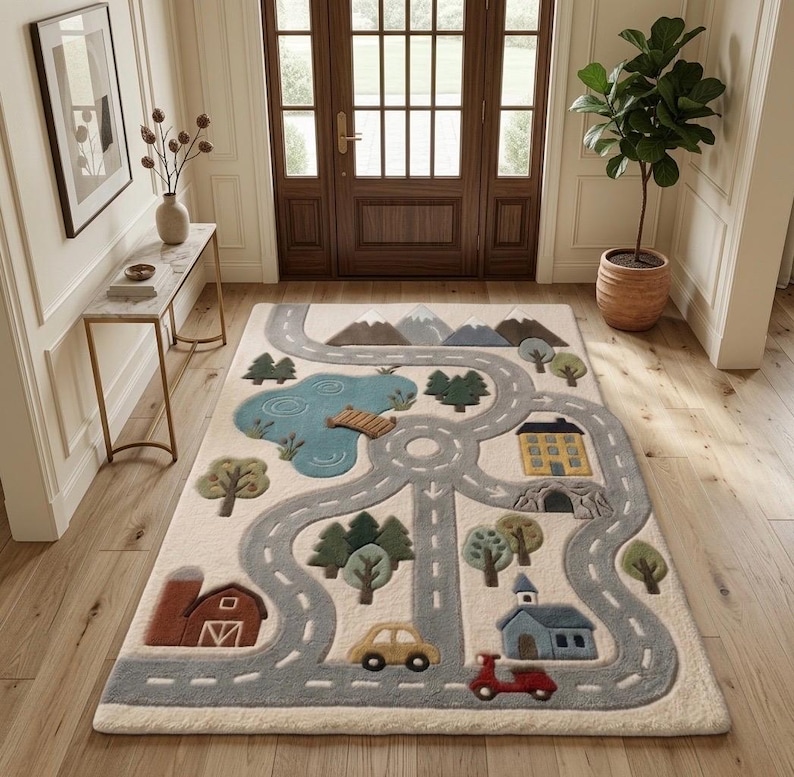May include: A rectangular area rug featuring a cream background with a gray road network, a blue lake with a wooden bridge, green trees, brown mountains, a red barn, a yellow house, a blue building, a yellow car, and a red scooter.