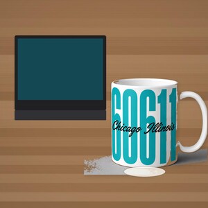 May include: A white ceramic mug featuring large, bold, teal-coloured numbers reading 60611, with the text Chicago Illinois written in a black cursive script across the centre. The mug has a standard handle and a cylindrical shape.