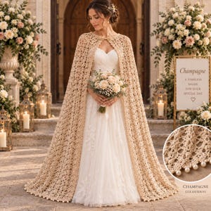 May include: A floor-length beige crochet cape featuring an intricate openwork pattern and a scalloped hem adorned with small white pearls. The cape is worn over a white strapless gown, with a circular inset showing the detailed crochet texture.