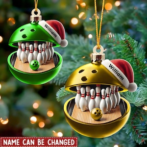 May include: Two spherical Christmas ornaments, one green and one gold, each featuring a bowling ball design that opens to reveal a miniature bowling lane with pins and a ball inside. Each ornament wears a red Santa hat with the name William printed.