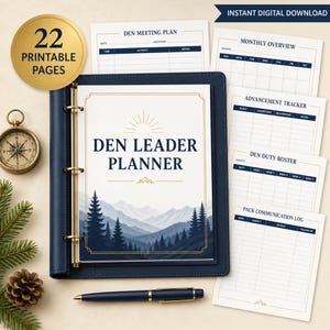 May include: A navy blue binder containing a Den Leader Planner with a mountain and pine tree graphic. The cover features the text Den Leader Planner. Included are 22 printable pages such as a Den Meeting Plan, Monthly Overview, Advancement Tracker, Den Duty Roster, and Pack Communication Log, alongside a navy blue pen.