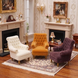 May include: Three miniature tufted armchairs in cream, mustard yellow, and dark plum, each featuring a high back, rolled arms, and small wooden legs. These dollhouse-scale chairs are arranged on a patterned rug in a room with a fireplace.