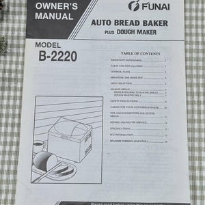 May include: An owner's manual for a Funai Auto Bread Baker Plus Dough Maker, model B-2220. The manual features a table of contents, safety precautions, and instructions. An illustration of the bread maker, a cup, and sliced bread is also included.
