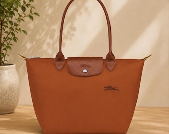 Bolso tote Longchamp de nailon marrón con detalles de piel, ideal para el día a día.