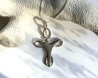 May include: A silver angel pendant necklace with a delicate chain. The angel is depicted with outstretched wings and a simple, stylized body.