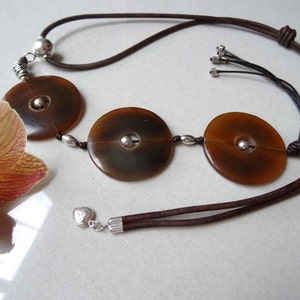 Long vertical necklace. Sterling silver, leather and large catle horn beads.