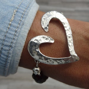 Hammered heart bracelet. Sterling silver and 8mm red Swarovski crystal beads.