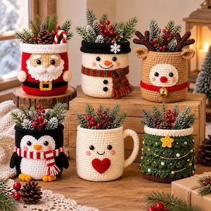 May include: Six crocheted containers featuring holiday designs including Santa Claus, a snowman, a reindeer, a penguin, a mug with a heart, and a Christmas tree. Each container is filled with artificial pine branches, pinecones, and red berries.
