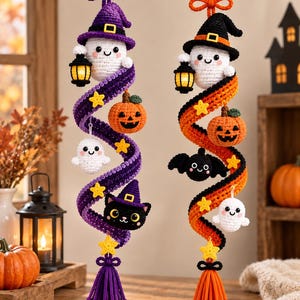 May include: Two hanging crochet decorations featuring Halloween themes. The left spiral is purple with a ghost, a pumpkin, a black cat, and yellow stars. The right spiral is orange with a ghost, a pumpkin, a bat, and yellow stars. Both have tassels.