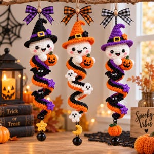 May include: Three hanging crochet ornaments featuring white ghosts wearing witch hats in black, orange, and purple. Each ghost holds a small orange pumpkin. The bodies are spiral-shaped with attached bats, stars, and ghosts, finished with a bell.