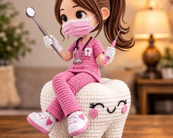 May include: A crocheted doll dressed in pink scrubs and a matching face mask, wearing a stethoscope and holding dental tools. The doll sits atop a large, white, crocheted tooth with a smiling face, pink cheeks, and white sneakers with pink hearts.