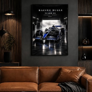 May include: A framed wall poster featuring a dark blue and black Formula 1 race car inside a garage. The text reads RACING BULLS, VCARB 03, FAENZA ITALY, 2026. The car is positioned centrally with reflections visible on the dark, wet-looking floor.