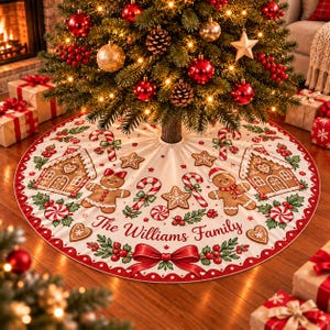May include: A round white Christmas tree skirt featuring a festive pattern of gingerbread houses, gingerbread people, candy canes, stars, and holly berries. The text The Williams Family is printed in the center with a red bow at the bottom.